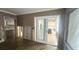Spacious living room featuring hardwood floors, updated lighting, and sliding glass doors at 4772 Dover Ne St, St Petersburg, FL 33703