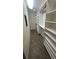 Bright walk-in closet features custom shelving and modern wood look flooring at 4772 Dover Ne St, St Petersburg, FL 33703
