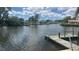 View from the backyard featuring a dock on calm waters in a residential neighborhood at 4772 Dover Ne St, St Petersburg, FL 33703