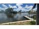 Scenic water view featuring a private dock, serene canal, and blue skies with fluffy white clouds at 4772 Dover Ne St, St Petersburg, FL 33703