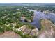 An aerial view shows houses, lake, and trees at 5058 Westlake Blvd, Dade City, FL 33523
