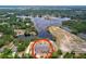 Aerial view of the home, showing the screened-in lanai, backyard, and proximity to the lake at 5058 Westlake Blvd, Dade City, FL 33523