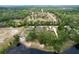 Aerial view of the property showcasing its location amidst lush trees, and a glimpse of the nearby lake at 5058 Westlake Blvd, Dade City, FL 33523