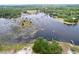 Panoramic aerial view of a scenic lake surrounded by lush greenery, highlighting the natural beauty of the area at 5058 Westlake Blvd, Dade City, FL 33523