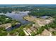 An aerial view shows houses, lake, and trees at 5058 Westlake Blvd, Dade City, FL 33523