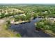 Aerial perspective revealing a property near a serene lake and lush trees, offering a blend of nature and convenience at 5058 Westlake Blvd, Dade City, FL 33523