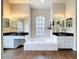 Bathroom with dual vanities, soaking tub and large window providing natural light at 5058 Westlake Blvd, Dade City, FL 33523