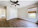 Bedroom with wood-look flooring, a window, and closet with folding doors at 5058 Westlake Blvd, Dade City, FL 33523