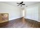 Bedroom featuring wood-look floors, a ceiling fan, and closet with double doors for storage at 5058 Westlake Blvd, Dade City, FL 33523