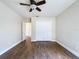 Spacious bedroom with wood-look flooring, a ceiling fan, and a closet with folding doors at 5058 Westlake Blvd, Dade City, FL 33523
