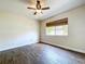 Bedroom showcasing hardwood floors, a ceiling fan and a window to allow for natural light at 5058 Westlake Blvd, Dade City, FL 33523