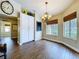 Bright dining area boasts wood floors, a stylish chandelier and a built-in cabinet for storage at 5058 Westlake Blvd, Dade City, FL 33523