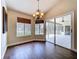 Elegant dining area features wood floors, a decorative chandelier and access to the outdoor patio at 5058 Westlake Blvd, Dade City, FL 33523