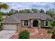 Inviting single-story home with a well-maintained lawn, mulch landscaping, and a covered front porch at 5058 Westlake Blvd, Dade City, FL 33523