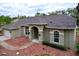 Well-maintained home featuring an arched entryway, two-car garage, mulch landscaping, and a cozy front yard at 5058 Westlake Blvd, Dade City, FL 33523