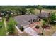 Aerial view of a beautiful home with mature trees, lake view, well-maintained lawn and mulch landscaping at 5058 Westlake Blvd, Dade City, FL 33523