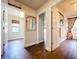 Hallway with tile flooring and white doors leads to the laundry room and the bathroom at 5058 Westlake Blvd, Dade City, FL 33523