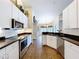 Well-equipped kitchen featuring granite countertops, stainless steel appliances, and white cabinets at 5058 Westlake Blvd, Dade City, FL 33523