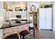 Bright kitchen with white cabinetry, a brick-accented bar, and hardwood-style floors at 5058 Westlake Blvd, Dade City, FL 33523