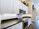 Well-lit kitchen showcasing granite countertops, stainless steel appliances, and white cabinets at 5058 Westlake Blvd, Dade City, FL 33523