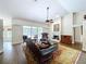 Living room with fireplace, high ceilings, and plush furnishings for a relaxing space at 5058 Westlake Blvd, Dade City, FL 33523