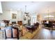 Open-concept living room with fireplace, hardwood floors, and dining room in the background at 5058 Westlake Blvd, Dade City, FL 33523