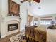 Main bedroom boasts a fireplace, wood floors, a ceiling fan, and ample natural light at 5058 Westlake Blvd, Dade City, FL 33523