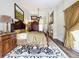This main bedroom features wood floors, a ceiling fan, fireplace, and access to the patio at 5058 Westlake Blvd, Dade City, FL 33523