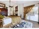 Spacious main bedroom with wood floors, a fireplace and a slider door to a screened patio at 5058 Westlake Blvd, Dade City, FL 33523