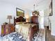Luxurious main bedroom with wood floors, a ceiling fan, artwork, and elegant furnishings at 5058 Westlake Blvd, Dade City, FL 33523