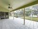 Covered outdoor patio with screen enclosure with views of yard, trees, and lake at 5058 Westlake Blvd, Dade City, FL 33523