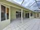 Covered outdoor patio with white pillars and tile flooring; part of screened enclosure at 5058 Westlake Blvd, Dade City, FL 33523