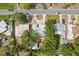 Aerial view showcases home's tile roof, large trees, storage shed and lush landscaping at 5826 20Th S Ave, Gulfport, FL 33707