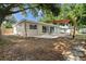 Exterior of home featuring a patio, sliding glass doors, and canopy in backyard at 5826 20Th S Ave, Gulfport, FL 33707