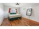 This bedroom has sleek hardwood floors, a ceiling fan and a full length mirror at 5826 20Th S Ave, Gulfport, FL 33707