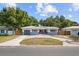 Inviting single-story home with blue accents, a private garage, and a spacious driveway at 5826 20Th S Ave, Gulfport, FL 33707