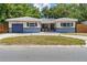 Charming single-story home with blue accents, a well-manicured lawn, and a private garage at 5826 20Th S Ave, Gulfport, FL 33707
