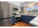 Beautiful kitchen boasts stainless appliances, granite counters, and blue and gray cabinets at 5826 20Th S Ave, Gulfport, FL 33707
