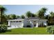 Beautiful one-story home with a two car garage, complemented by lush landscaping and stately palms at 6 Simonton Ave, North Port, FL 34286