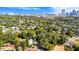 Aerial view showcases a neighborhood with tree-lined streets and a city skyline in the background, blending urban and natural elements at 601 Newton S Ave, St Petersburg, FL 33701