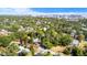 An aerial view reveals a neighborhood with lush trees and houses nestled in the landscape with a skyline on the horizon at 601 Newton S Ave, St Petersburg, FL 33701