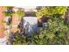 Aerial view of a home with a gray roof surrounded by mature trees, offering shade and a sense of seclusion at 601 Newton S Ave, St Petersburg, FL 33701