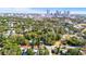 Aerial view shows a neighborhood with lush trees and a city skyline, blending urban convenience with suburban tranquility at 601 Newton S Ave, St Petersburg, FL 33701