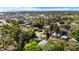 An aerial view shows a neighborhood with lush trees and houses nestled in the landscape near a body of water at 601 Newton S Ave, St Petersburg, FL 33701