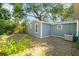 Cozy home with a fenced in backyard featuring a tree, and grass at 601 Newton S Ave, St Petersburg, FL 33701