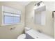 Bathroom with updated vanity, mirror, and window at 601 Newton S Ave, St Petersburg, FL 33701