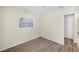 Bright bedroom features wood-look flooring, neutral paint, and a window at 601 Newton S Ave, St Petersburg, FL 33701