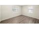 Sunlit bedroom featuring two windows and modern wood-look flooring at 601 Newton S Ave, St Petersburg, FL 33701