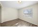 Bright, empty bedroom with wood-look floors and a large window at 601 Newton S Ave, St Petersburg, FL 33701