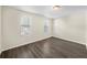 Bedroom with wood-look floors and two windows at 601 Newton S Ave, St Petersburg, FL 33701